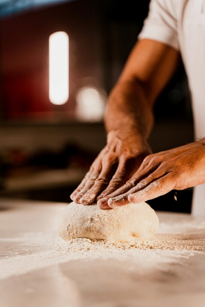 Close-up of hands kneading dough, capturing the essence of baking.